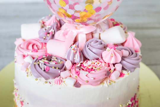 A piece of cake with marshmallows, sweets in pink and lilac colors.
