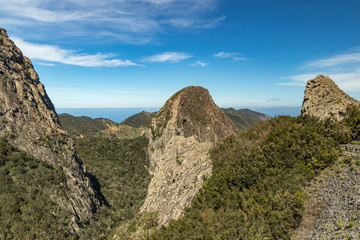 Panoramic view of Rocks - Los Roques in La Gomera island. A volcanic plug, also called a volcanic neck or lava neck, is a volcanic object created when magma hardens within a vent on an active volcano
