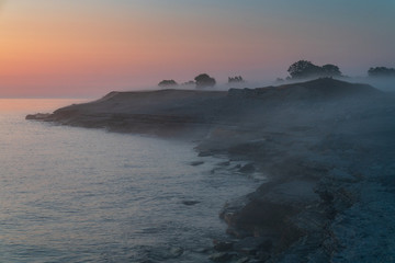 Stone wall on the Baltic sea in the summer. Osmussaar coast, island in Estonia, Europe.