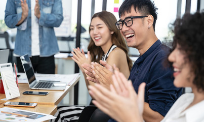 Happy Asian business clapping hands after business meeting successful in modern office
