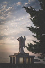 Fototapeta premium cristian saint statue at the sunset