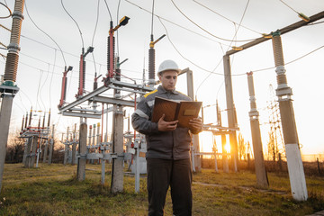 The energy engineer inspects the equipment of the substation. Power engineering. Industry