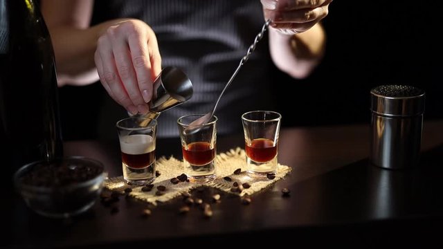 Bartender making a layered cocktail shot