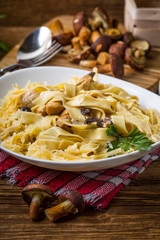 Tagliatelle pasta with forest mushrooms and chicken.