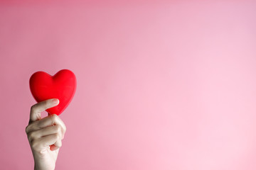 hand carrying heart .love and cardio health concept.valentine and wedding theme.