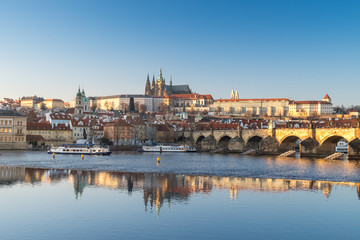 Fototapeta na wymiar Panorama of winter Prague with reflection in the Vltava river of the Cathedral of St. Witt, Mala Strana, Charles Bridge at sunset