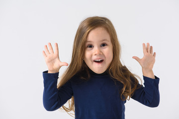 portrait of a little emotional girl who is surprised, smiling, on a white background