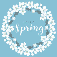 Cherry blossom round frame with hello Spring lettering on a blue background