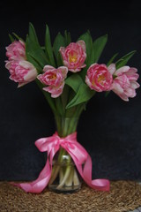 Pink Tulips in vase and ribbon dark background