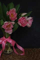 Pink Tulips in vase and ribbon dark background