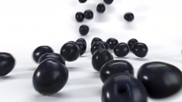Many black olives rolling down on white surface. Close up of fresh 3D realistic vegetables falling and roll. 4K render animation footage.