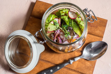 fresh vegetables in a glass jar in a restaurant. Cabbage and radish with sauce