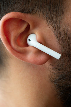 One Of The Airpods On An Ear.