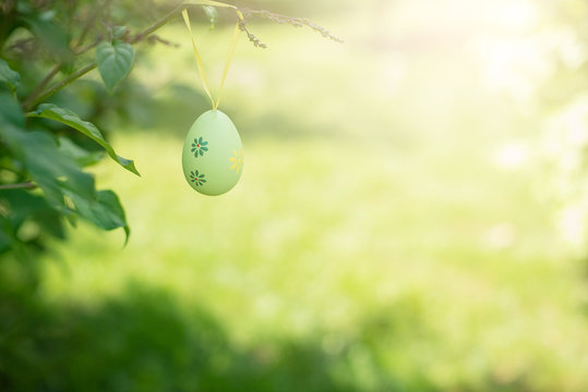 Decorative Easter Egg Hanging On Flowering Tree. Easter Background. Family Celebration, Christian Traditions. Holiday Greeting Card Template.