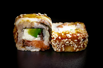 Close up composition of tuna maki sushi rolls japanese food style on a black background