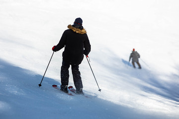Fototapeta na wymiar Skier jumping and having fun at resork in winter form the back