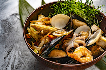 Japanese ramen soup with tofu on dark stone background. Miso soup with ramen noodles and tofu in ceramic bowl, asian traditional food.