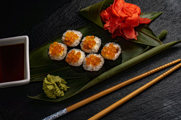 Obraz na płótnie Canvas Set of sushi with wasabi and chopsticks on slate
