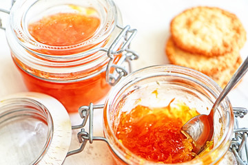Delicious homemade orange marmalade on the kitchen table, soft focus