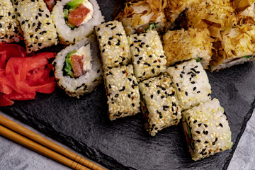 Set of sushi with wasabi and chopsticks on slate