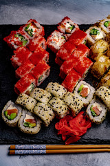 Set of sushi with wasabi and chopsticks on slate