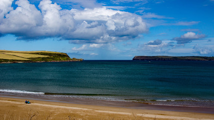 Obraz premium Harbour Cove a tranquil spot on the River Camel estuary in North Cornwall. An ideal sheltered spot to watch passing clouds and the open sea.