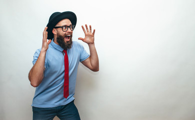 Naklejka premium Portrait of amazed hipster man with beard, wearing casual. Your text here. Wow!
