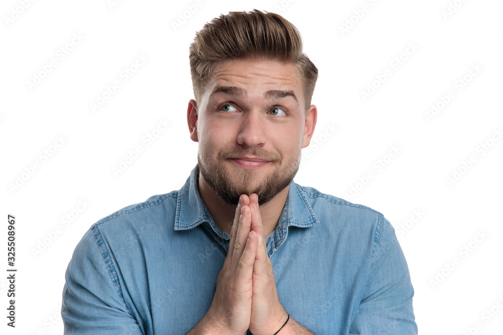 Sticker Positive casual man praying and looking up