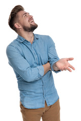 Happy casual man laughing and talking while looking up