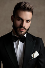 Confident groom looking forward while wearing tuxedo
