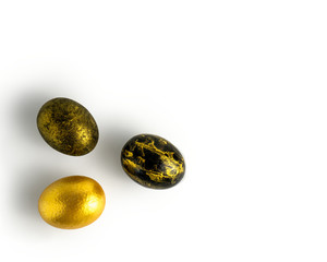 Easter eggs painted in gold and black marble colors on a white background. With the Easter holiday. Isolated