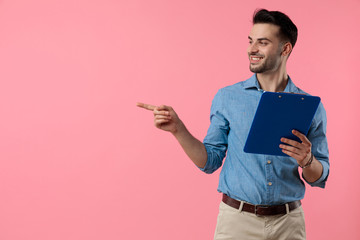 happy young guy smiling and pointing finger