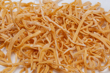 Homemade noodles on a white background.