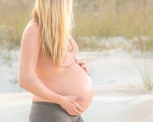 pregnant woman touching her belly 