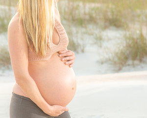 pregnant woman touching her belly with her hand