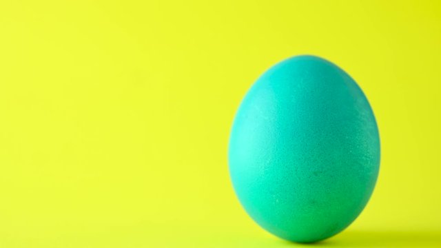 Colorful easter egg on a yellow background. Easter concept background.