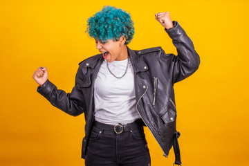 young modern brunette girl with curly blue hair of afro american ethnicity isolated on color background