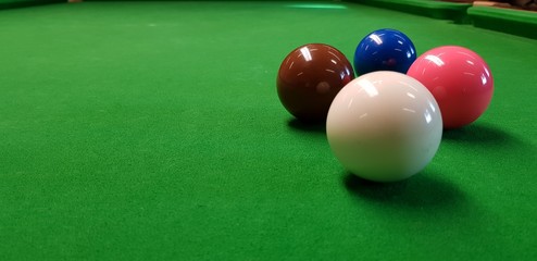 billiard balls on a green table 