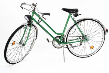Aluminium Prints Bike An old retro looking green vintage city bicycle for women, isolated o white background. Side view