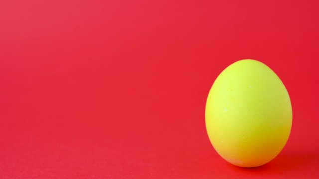 Colorful easter egg on a red background. Easter concept background.