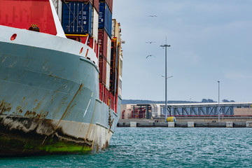 Side view of a container ship moored in the harbor