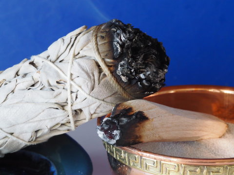 Sage And Palo Santo Smudging Sticks With Blue Background