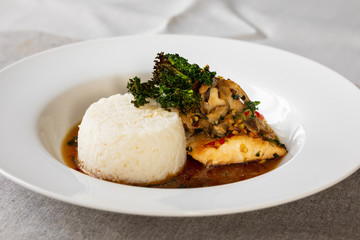 Cod with shiitake mushrooms and rice in asian spicy broth