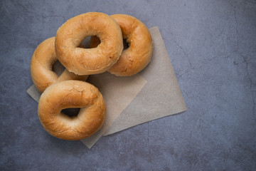 Homemade bagels on baking paper. Top view. Copy space.