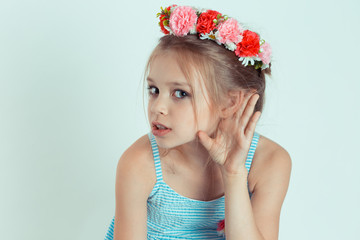 Happy kid girl hand to ear eavesdropping trying to hear to a chipchat