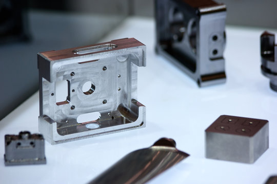 Disassembled metal components. Steel shiny blocks. Metal objects.