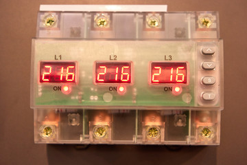 Electronic control box with buttons. Three phases, red number on led display.