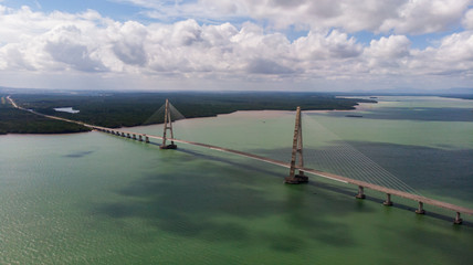 The Johor Bridge at the south of Malaysia from the sky. Cars passing by on the Bridge.  Pass the ocean bay near the city of Singapore. The Highway ends at Desaru Coast, holiday resort for Singaporeans