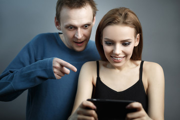 Man with cute girl looking at the smartphone
