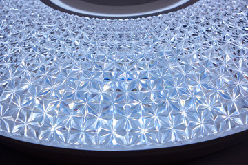 Metallic pyramid steel plate. Round shiny patterned 3d waves.